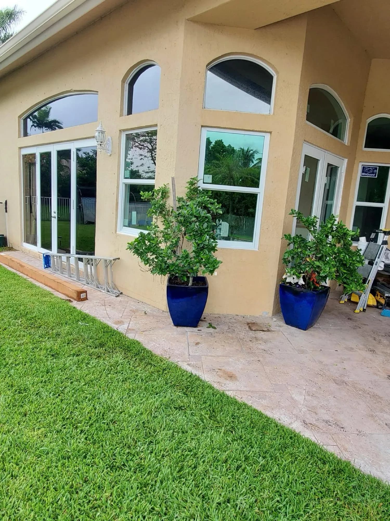 White French patio doors with arched transom windows on a South Florida home patio