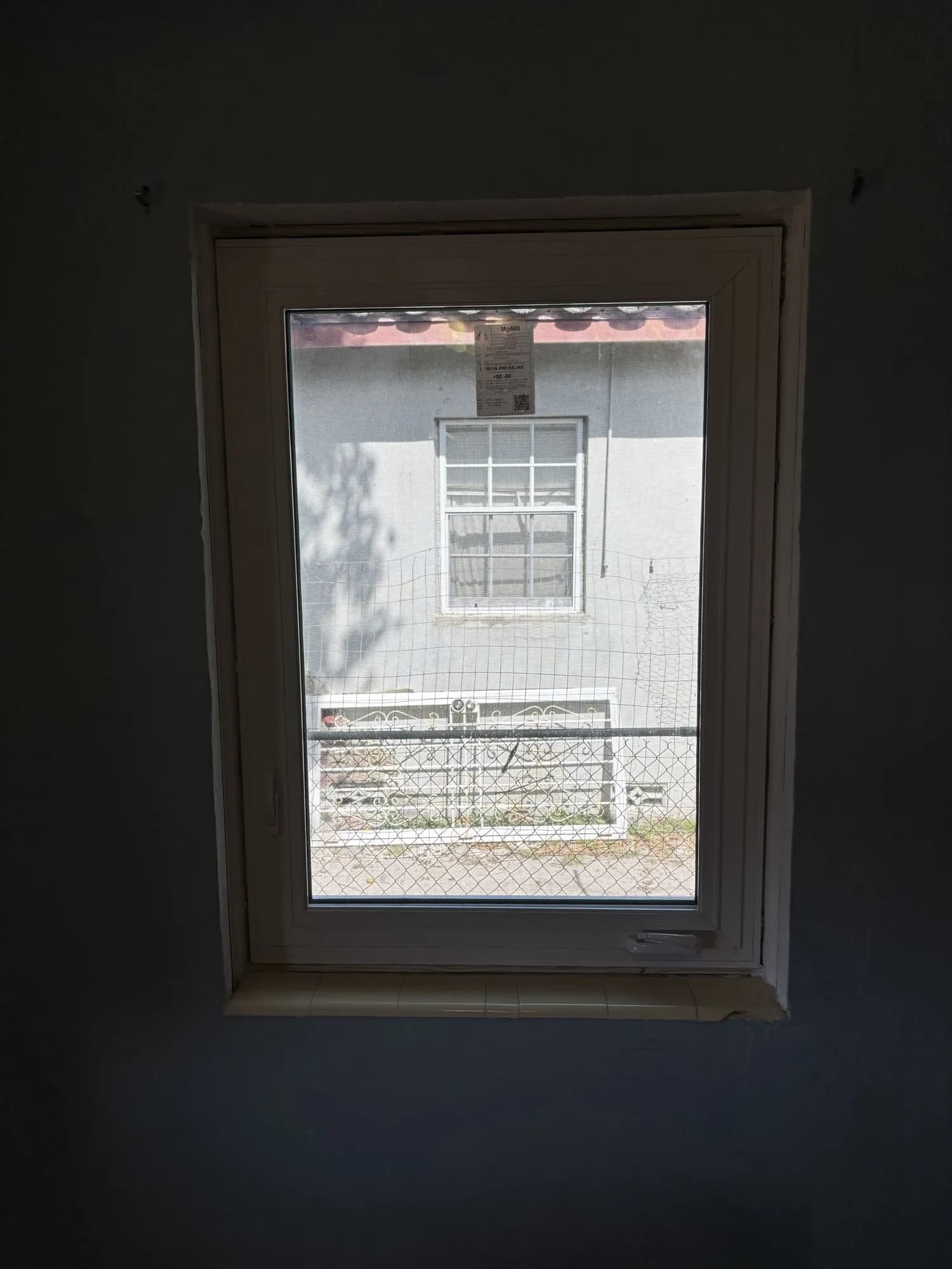 Interior view of a newly installed white casement window